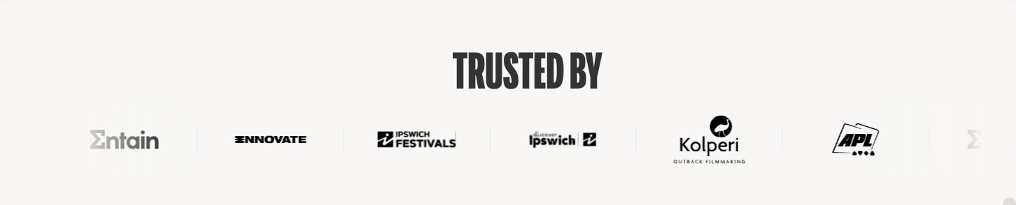 Trusted By logo bar with centered dark heading and grayscale client logos on light background captured website design