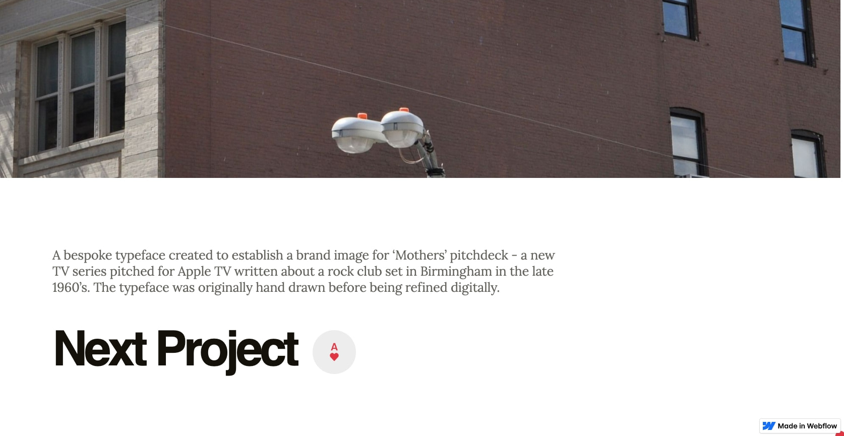 Mothers project case study with full-bleed brick building photograph, serif description, and bold Next Project link with circular icon captured website design